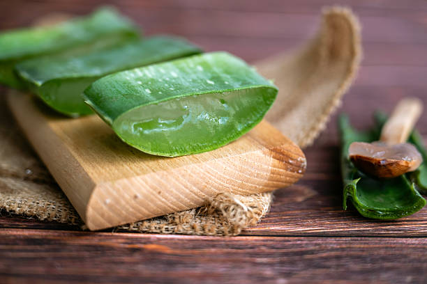 istock Aloe vera fresh leaves on wooden  background 2212195523