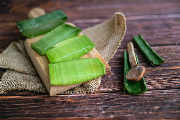 istock Aloe vera fresh leaves on wooden  background 2212195584