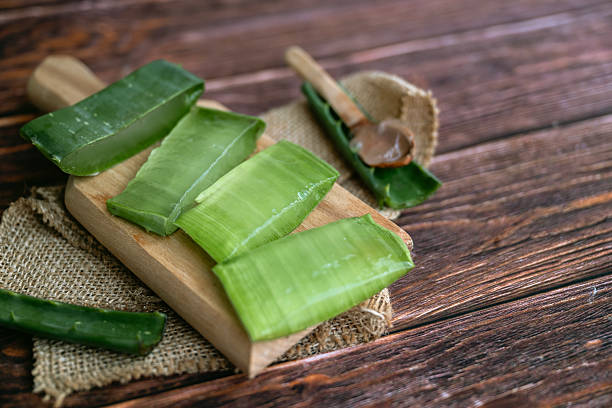 istock Aloe vera fresh leaves on wooden  background 2212195586