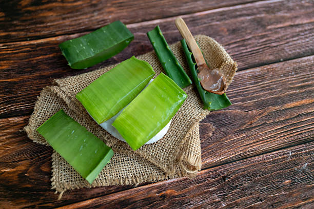 istock Aloe vera fresh leaves on wooden  background 2212195607