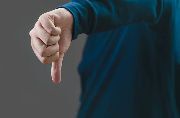 istock A hand showing a thumbs down gesture, symbolizing disapproval or negative feedback. Perfect for illustrating criticism or rejection in various contexts. 2212196277
