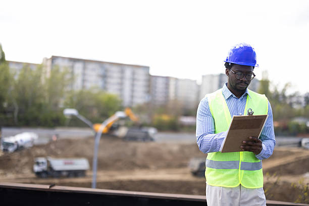 istock African American engineer overseeing progress at a busy construction site 2212199099