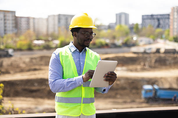 istock Black engineer directing works at the construction location 2212199119