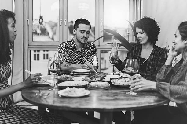 istock four people around wooden lunch table 2212199248