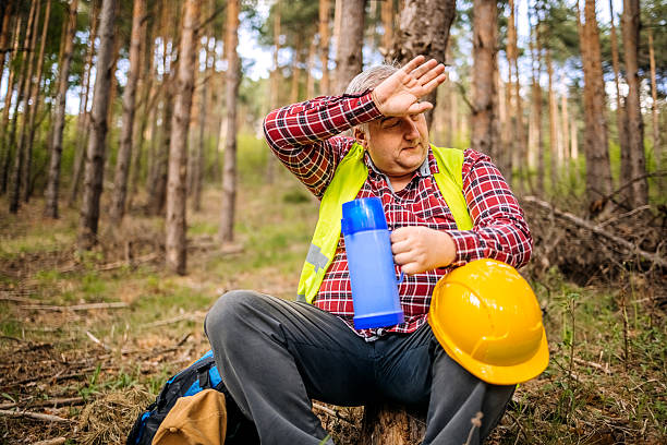 Man checking environment on mountain top, taking samples in nature to check for pollution and taking a break to drink a cup of water