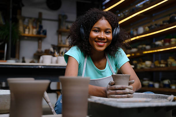 istock African woman make earth ware at workshop. 2212203008
