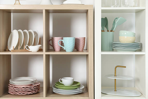 istock Shelving units with kitchenware near white wall indoors 2212205655