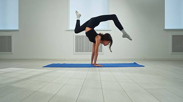 istock Young Woman Practicing Advanced Yoga Exercise Indoors 2212206689