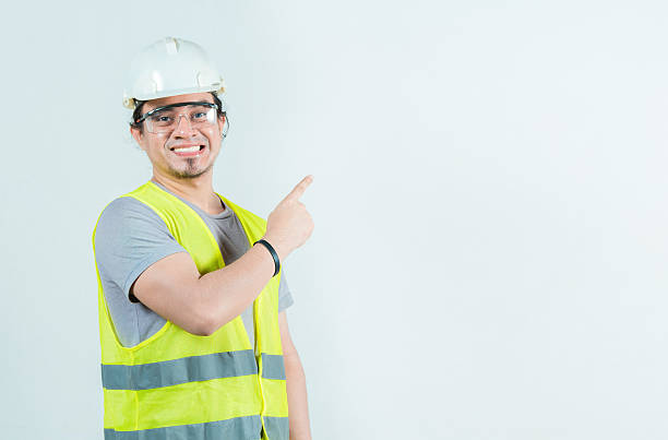 istock Happy male builder pointing to side isolated. Smiling male construction worker pointing blank space 2212208624
