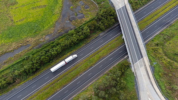 istock Semi trailer truck driving through lush countryside 2212210302