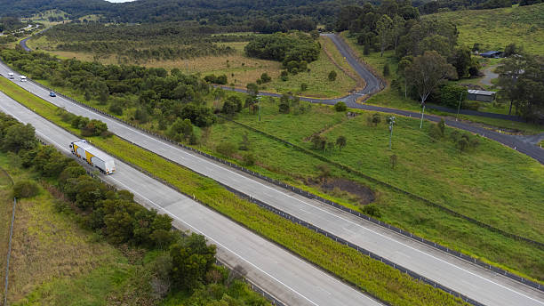 istock Semi trailer truck driving through lush countryside 2212210310