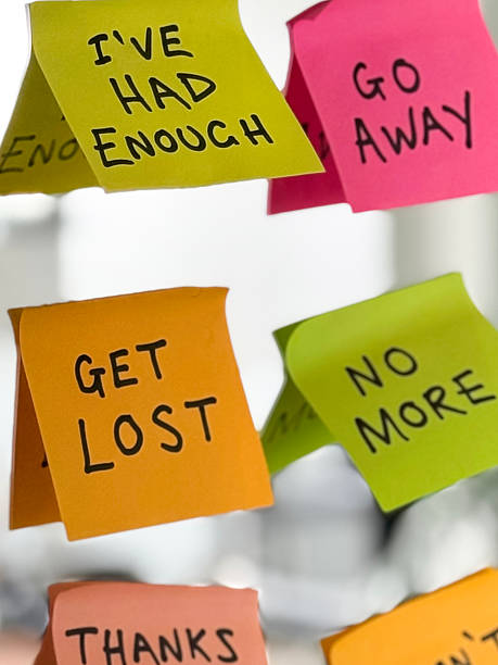 istock Image of get lost rude message on sticky note post-it leaving notes, bold words for office humor, sarcastic workplace notes 2212210692