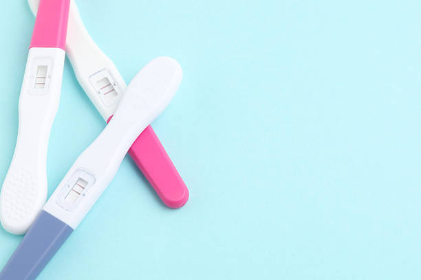 istock Pregnancy tests on light blue background, closeup. Space for text 2212212661