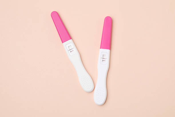 istock Pregnancy tests on beige background, top view 2212212684