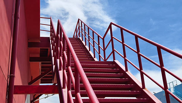 istock A set of stairs ascending a large red wall 2212214193