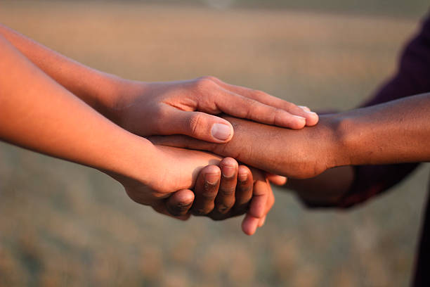 istock Many people's hands together and a blurred background 2212215032