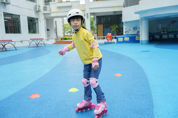 Little Asian girl roller skating