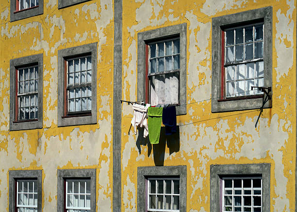 Calm scene with a white wall with two red towels hung out to dry