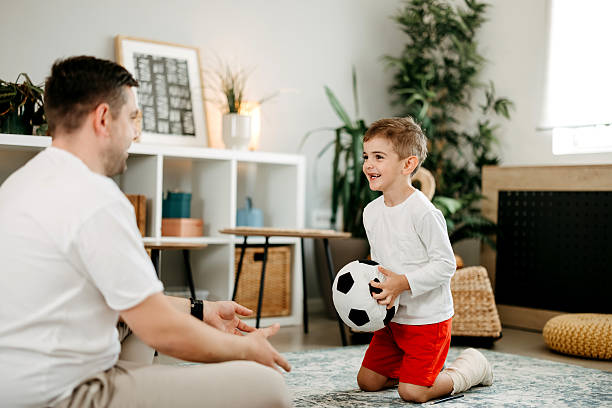 istock Father plays with son's ball 2212218116