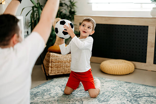 istock Father plays with son's ball 2212218135