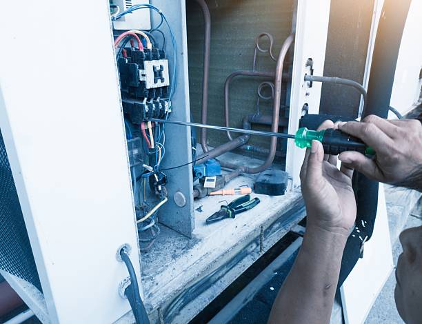 istock Technician is checking the power cable of air conditioning hvac compressor 2212220538