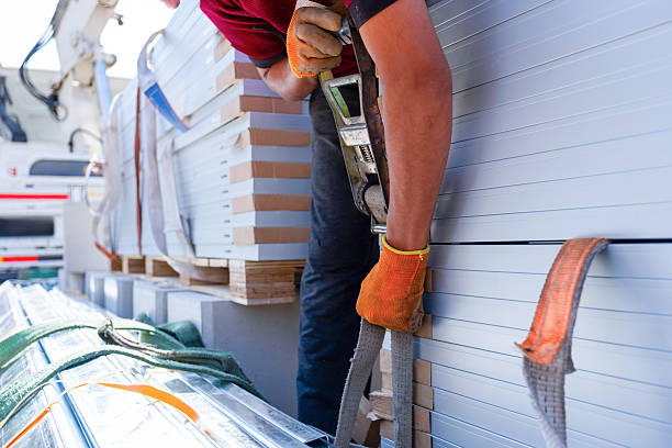 istock Worker Handling Metal Sheets on a Sunny Day Outdoors 2212220654
