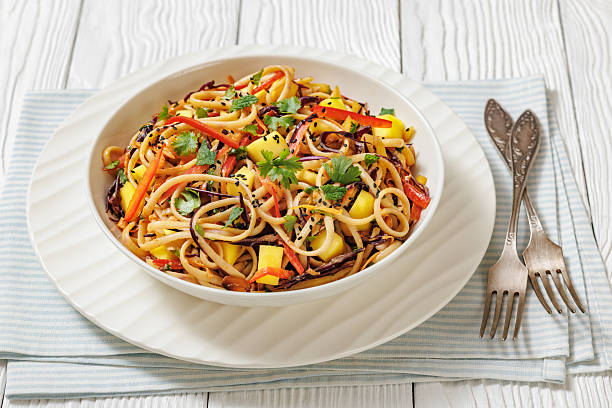 istock Thai Mango Noodle Veggie Salad in a bowl 2212220929