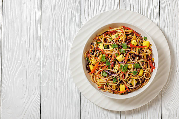 istock Thai Mango Noodle Veggie Salad in a bowl 2212221281