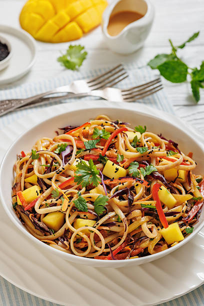istock Thai Mango Noodle Veggie Salad in a bowl 2212221366