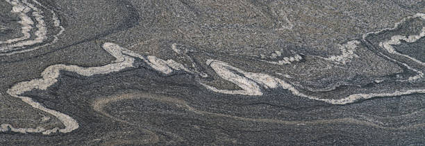 istock Granite texture in gray tones with curved natural patterns 2212223801