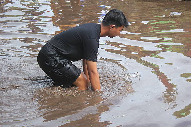 Hand of people taking dirty water from the drying pond, Water Crisis and Climate change issue