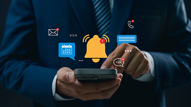 istock Businessman using smartphone to manage multiple notifications, including email, calendar events, phone calls, and messages, representing business communication, digital connection, and productivity 2212225205