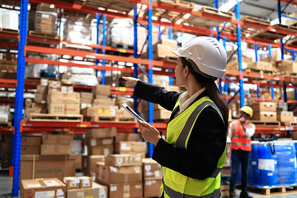 istock Logistic engineer team oversee a warehouse in a distribution center. Package supervisor for the warehouse 2212228481