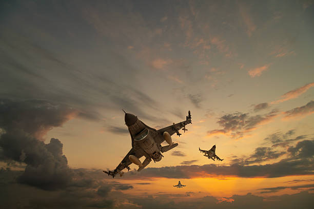 F-16 jet aircrafts flying at sunset.