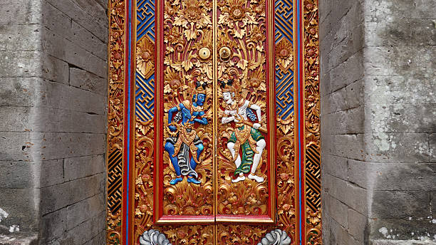 Traditional balinese handmade carved wooden door. Bali style furniture with ornament details Tirta Empul temple is an ancient Hindu Balinese water temple located near the town of Tampaksiring, Bali, Indonesia.