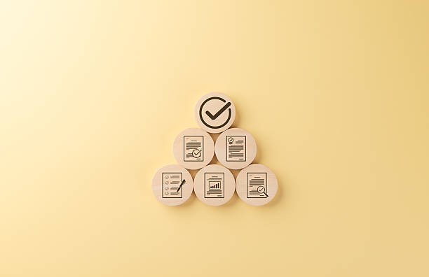 istock Quality control and certification assurance concept. Wooden blocks featuring quality control, certificate, and checklist icons, symbolizing standard, compliance, and management in business processes. 2212233546