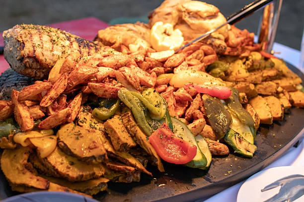 istock Colorful seafood platter featuring grilled shrimp and assorted vegetables, perfect for a festive dining experience. 2212235367