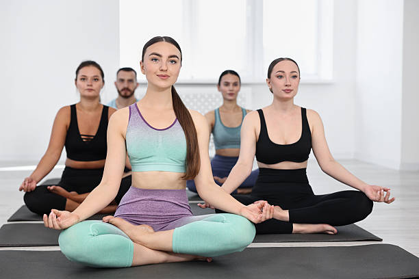 istock Group of people meditating on mats in yoga class 2212236272