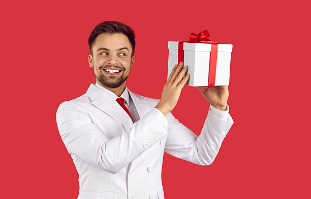 istock Smiling man in suit hold box greeting with special occasion 2212236390