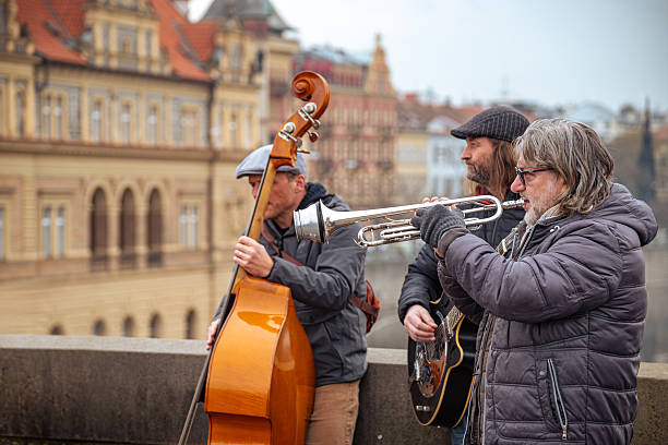 Street musicians. An unidentified jazz band of buskers perform on the historic Charles Bridge (Karluv Most) in the Old Town of Prague for tourists and locals. Czech Republic - February 25, 2025.