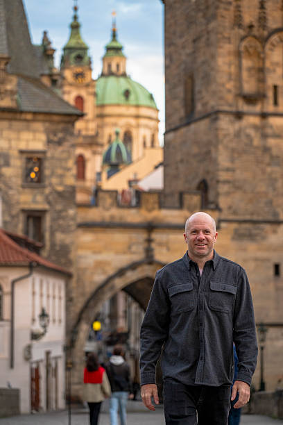 istock Man explores old town in city, Prague 2212236992