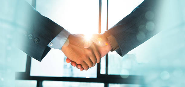 istock Trusted partner. Businessmen making handshake with partner, greeting, dealing, merger and acquisition, business cooperation concept, joint venture, Build trust in business and finance relationships. 2212239031