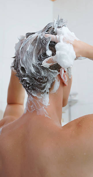 istock asian man washing hair 2212239131