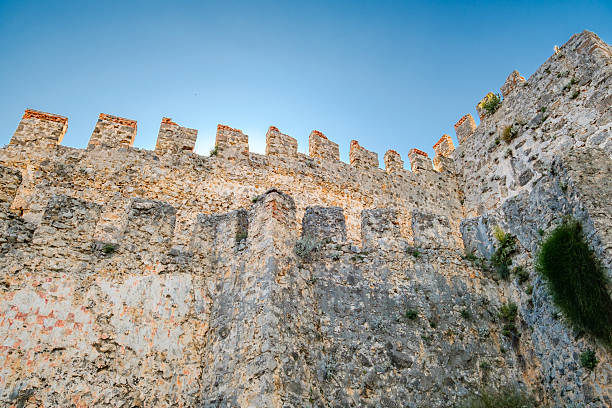 istock stone wall of fortress with merlons 2212242495