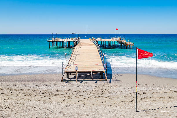 Access to the beach in swanage, dorset, with a metal railing and turquoise water