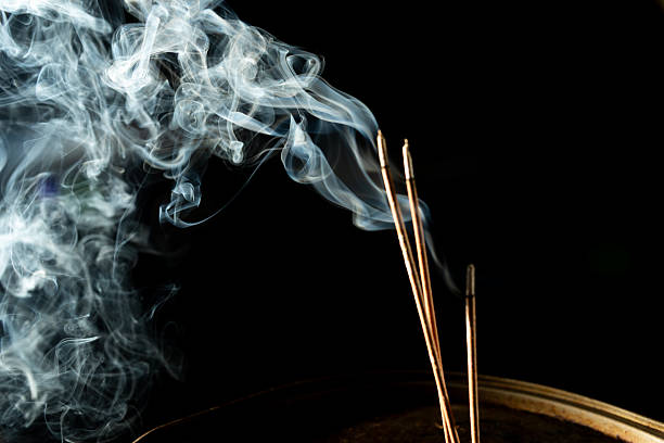istock Dancing incense smoke with light in the dark. 2212242993