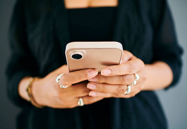 istock Woman's Hands Holding Smartphone With Stylish Rings 2212248363