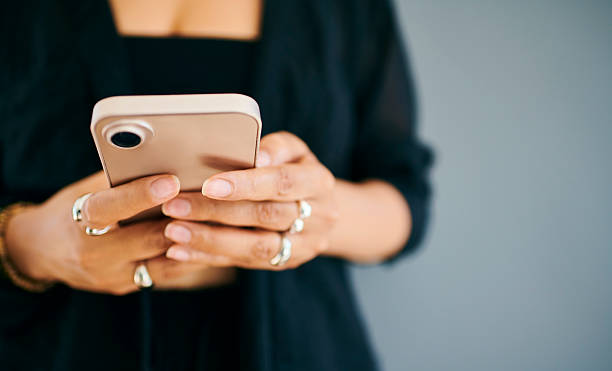 istock Close-Up of Hands Typing on Smartphone 2212248366
