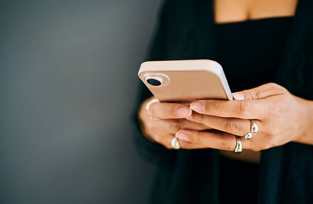 istock Close-Up of Hands Typing on Smartphone 2212248381