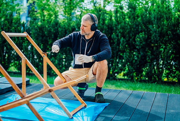 istock Man is impregnating a deck chair in the backyard. 2212249091